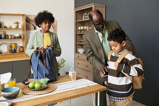 istock Mature Black Man Helping Black Boys Preparing for School Morning 2247172640