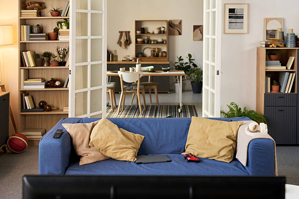 istock Empty Modern Living Room with Blue Sofa Facing Television in Cozy Apartment 2247172717