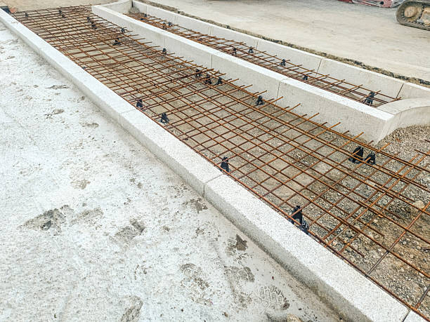 istock Rebar reinforcement in formwork for concrete steps and sidewalk before pour at jobsite 2247173303
