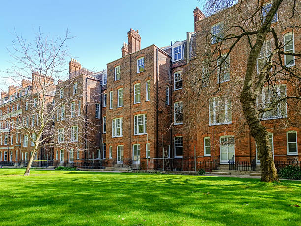 istock Historic red brick apartments with green courtyard lawn 2247173755