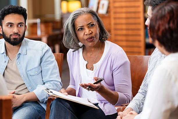 istock Diverse group engaging in counseling session with therapist providing support and guidance. 2247174171