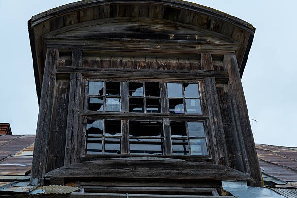 Broken Wooden Dormer Window on Abandoned Historic Building Roof
