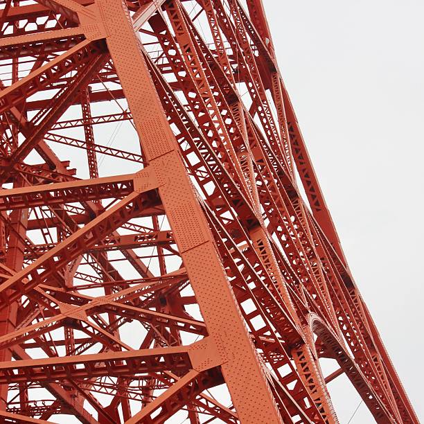 istock Red and White Communication Tower Rising Above Modern City Skyline 2247176754