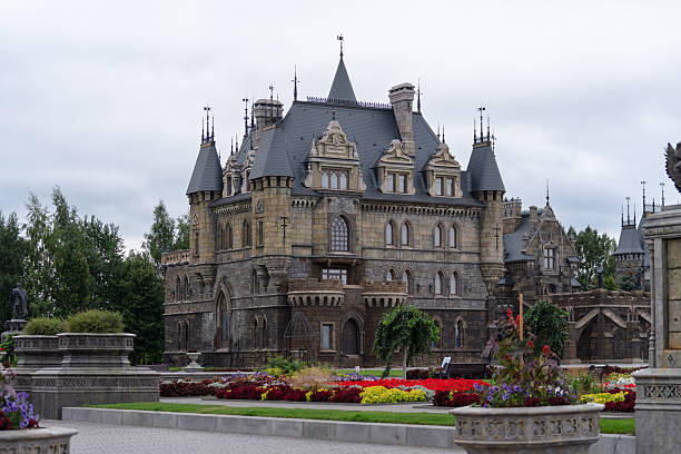 Russia, Samara Oblast, Khryashchevka village – July 31, 2023. General view of Garibaldi Castle on an overcast day, with flower beds in the foreground. Popular tourist attraction.