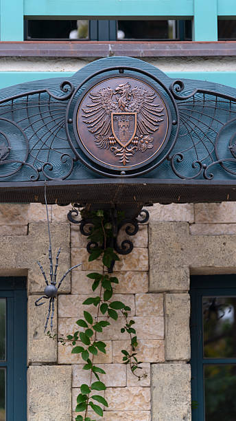 Russia, Samara Oblast, Khryashchevka village - July 31, 2023. Garibaldi Castle. Close-up of eagle and spider coat of arms above windows. Landmarks and architecture