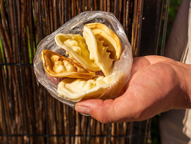 istock Hand holding traditional smoked cheeses in plastic bag 2247178305