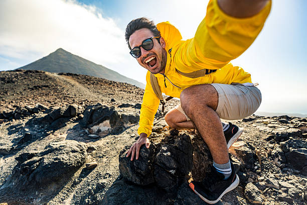 istock Happy hiker having fun hiking mountains - Active young man taking selfie pic with smart mobile phone device outdoors - Action cam, extreme sports and summertime holidays concept 2247179718