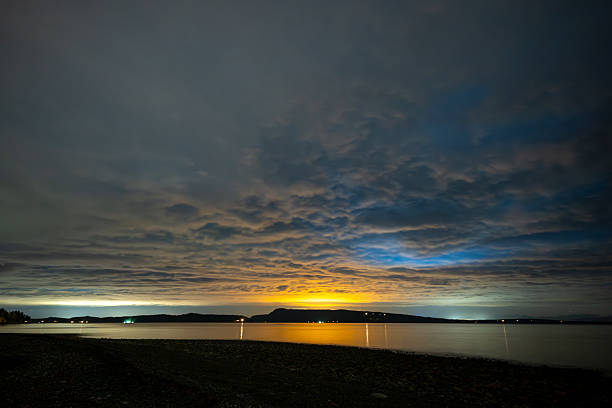 Northern Lights (aurora) through clouds, Bowser, Vancouver Island, British Columbia, Canada