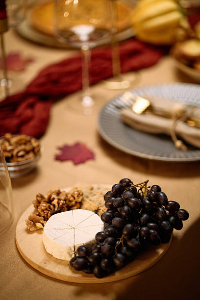 istock Close up of Cheese Grapes and Nuts Arranged on Table during Thanksgiving Dinner 2247179988