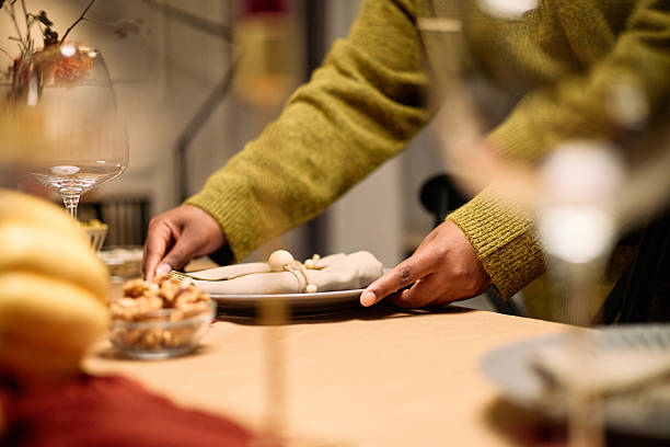 istock Young Adult Black Woman Setting Table during Thanksgiving Dinner Gathering 2247180835