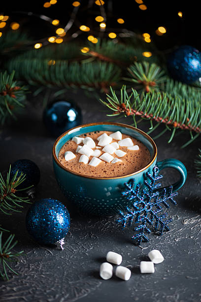 istock Hot Chocolate with Marshmallows in Teal Mug Surrounded by Christmas Decor 2247181089