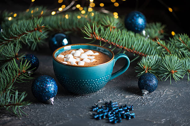 istock Hot Chocolate with Marshmallows in Teal Mug Surrounded by Christmas Decor 2247181092