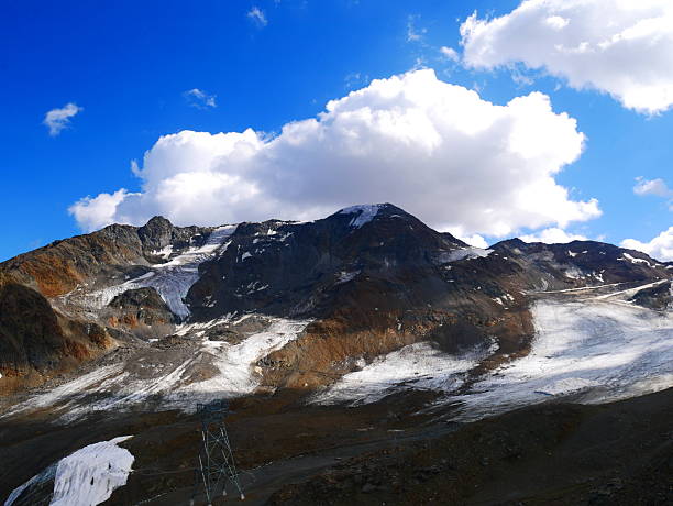 View on Weisseespitze peak (Cima del lago Bianco) in Kaunertal on a summer day,mountains, sky, clouds.  Alps, Austria. Creative post processing.
