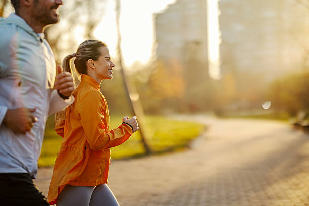 istock Happy couple jogging outdoor in park 2247182438