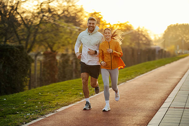 istock Couple jogging in park maintaining healthy lifestyle 2247183055