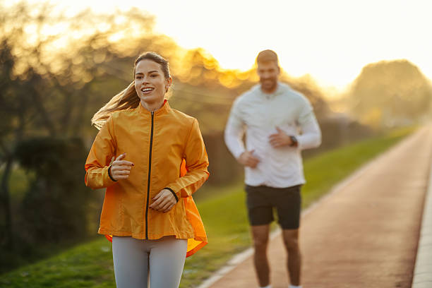 istock Happy couple jogging outdoors on a sunny morning 2247183060