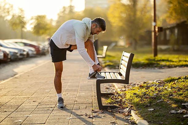 istock Male runner tying shoelace preparing for morning workout 2247183104