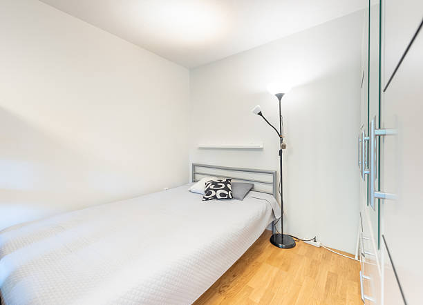 istock Minimalist Home Bedroom With Single Bed, Wooden Floor, and Modern Lighting 2247184015