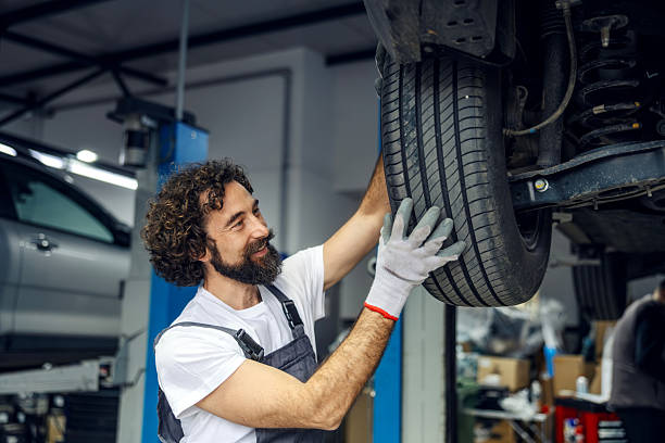 istock Mechanic installing tire on car in auto service garage 2247184302