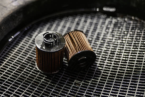 Used oil filters placed on a grid, showing the importance of regular car service and engine maintenance