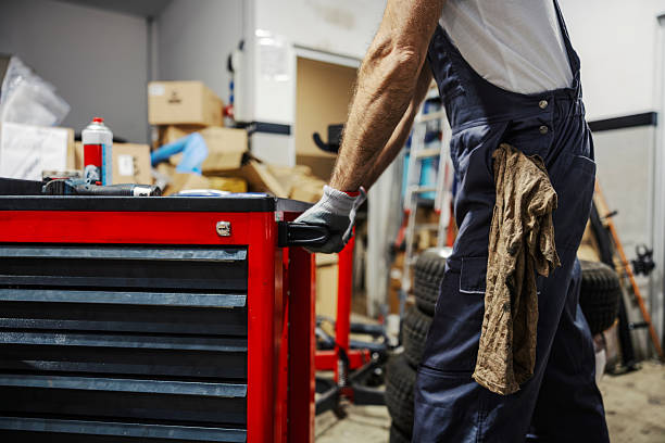 istock Mechanic opening tool chest in auto repair workshop 2247184428