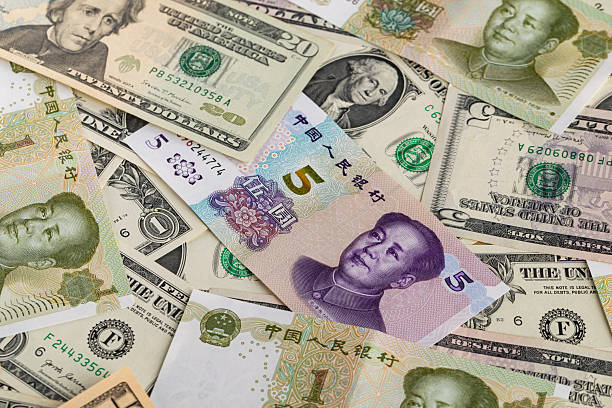 istock Chinese Five Yuan Banknote on Full Frame Background of Mixed US Dollar Bills 2247184506