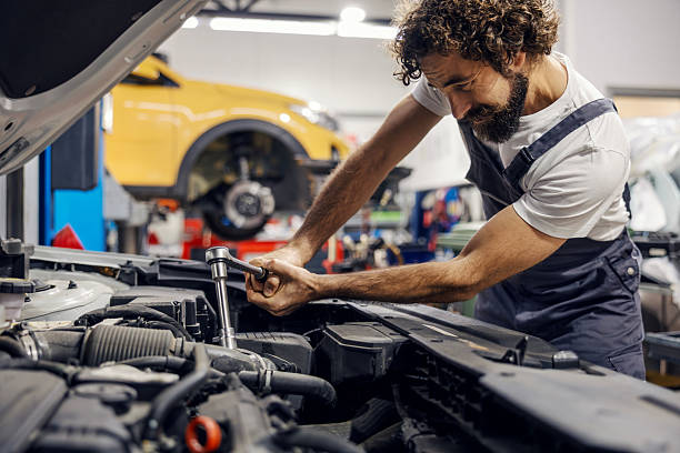 istock Mechanic working on car engine in auto service shop 2247184557