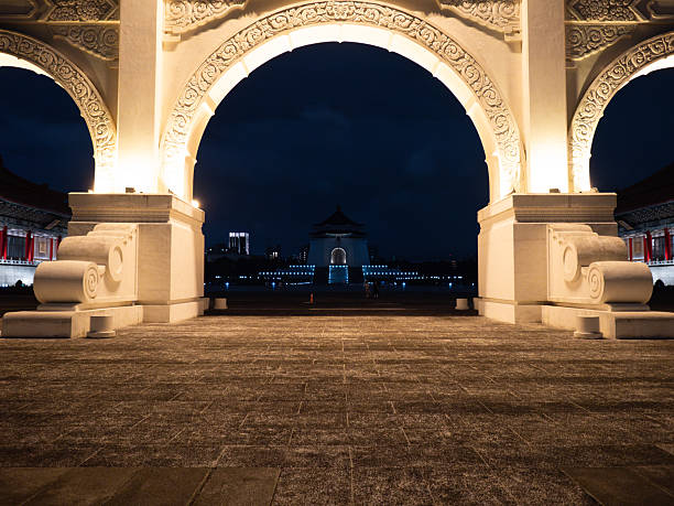 Taipei, Taiwan - November 17 2024: A view of the Chiang Kai-shek Memorial Hall, framed by the central arch of the illuminated main gate at Liberty Square.