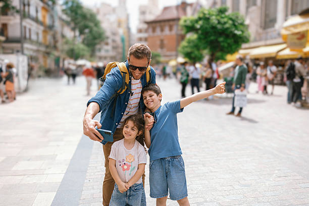 istock Father taking selfies with children in a pedestrian zone in Valencia 2247185393