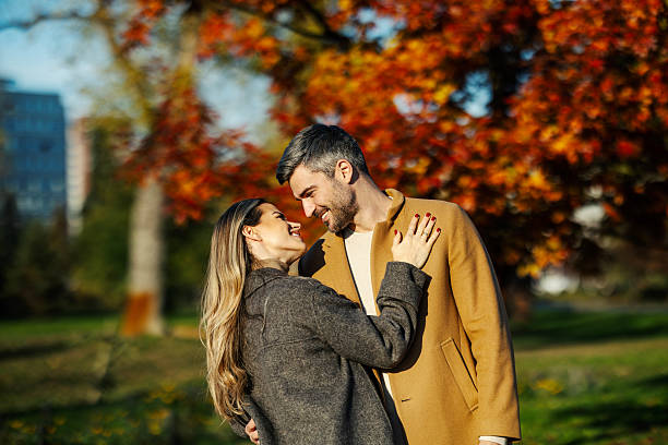 istock Happy couple enjoying autumn park looking at each other 2247186310