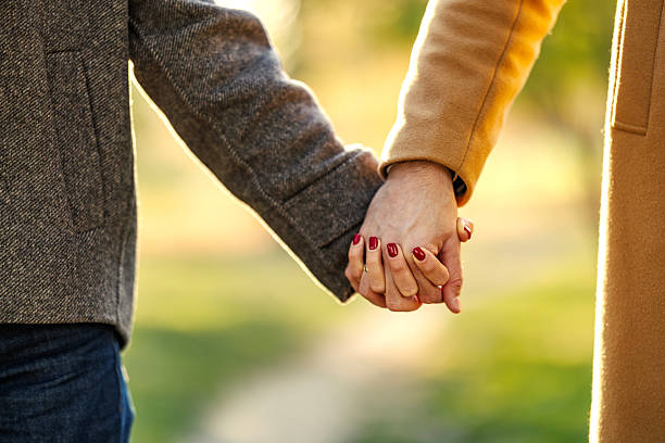istock Couple holding hands walking together during sunset 2247186434