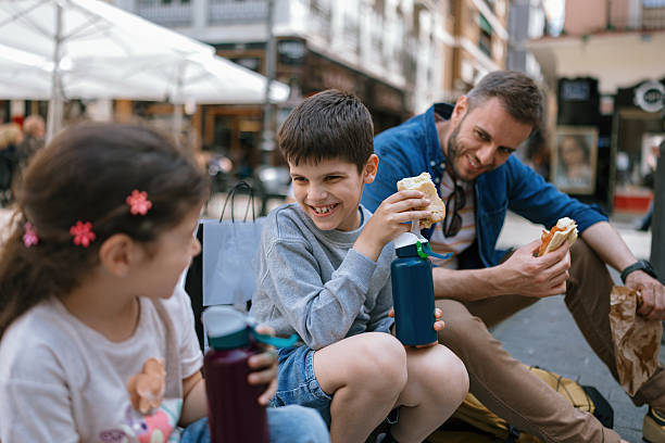 istock Children drinking water from reusable bottles during a lunch break 2247186837