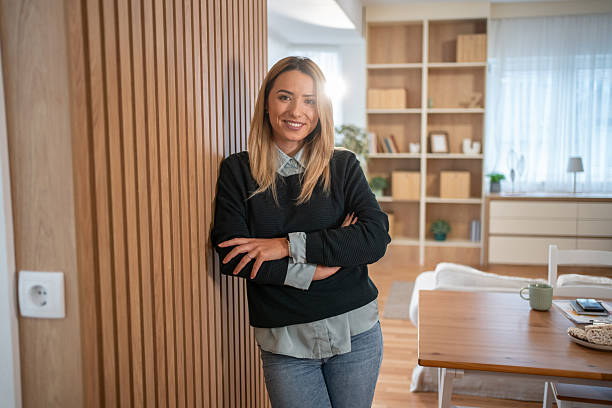 istock Confident young woman smiling in modern home interior 2247187244