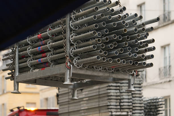 Row of stacked metal scaffolding at construction site. Framework