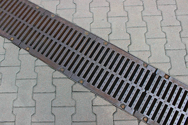 istock A rainwater drainage grate built into a continuous pattern of paving slabs at roadside 2247189771
