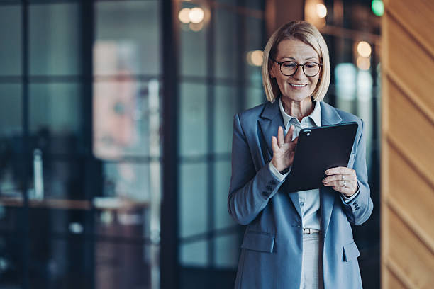 istock Mature businesswoman using digital tablet in a modern office 2247192172