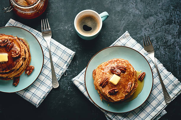 Stack of Sweetpotato Pancakes with Butter and Pecan Nuts