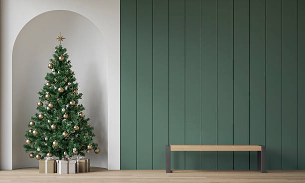 istock Modern minimalist interior decorated for Christmas, with a modern bench in front of sage green wooden slat / shiplap wall, a Christmas tree with presents in a wall niche, near a window 2247197355