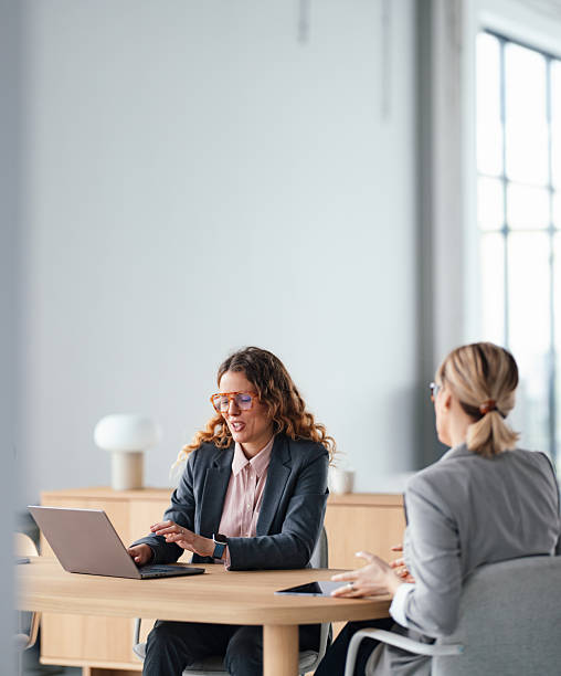 istock Professional Women In a Modern Office Meeting With Laptop And Documents 2247197760