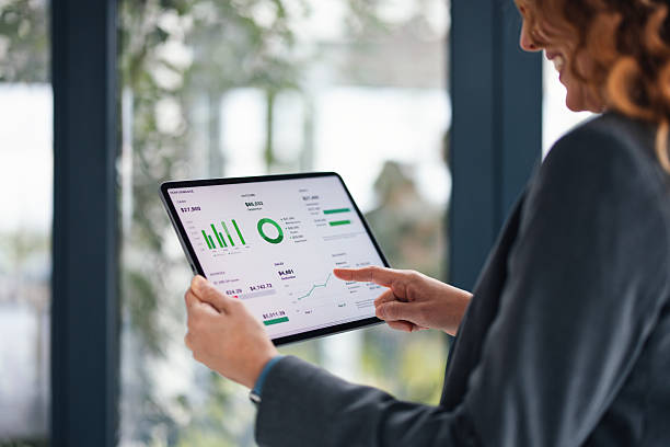 istock Businesswoman Analyzing Financial Dashboard on Tablet During Office Meeting and Presentation 2247197776