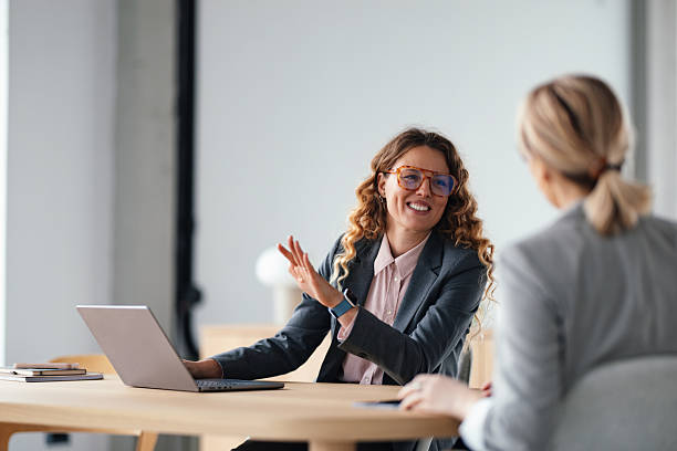istock Business Meeting: Friendly Woman Gesturing While Discussing Ideas With Colleague At Modern Office 2247197804