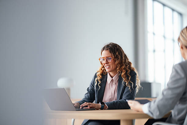 istock Professional Woman in Blazer Working on Laptop During Office Meeting 2247197806