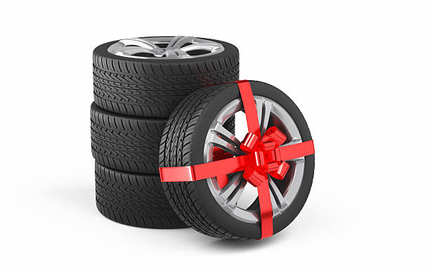 istock New Car Tires with Alloy Wheel Gift Wrapped in Red Ribbon, Object + Shadow Path 2247198093