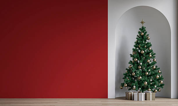 istock Modern minimalist unfurnished interior decorated for Christmas, with an empty red wall, a Christmas tree with presents in a wall niche, near a window 2247198100