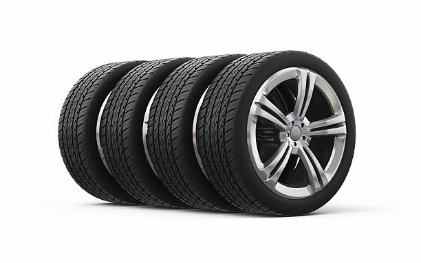 Car tires isolated on yellow background, close up photo
