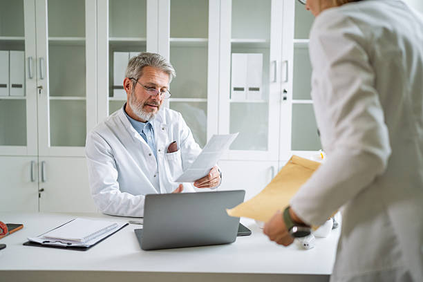 istock Medical professionals collaborating on documents and paperwork in clinic 2247200314