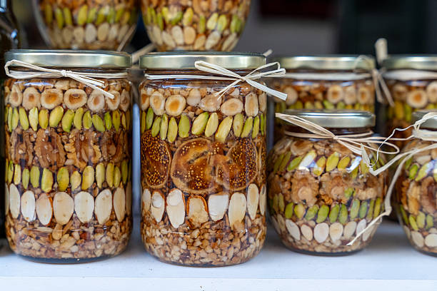 istock Assorted nuts and dried fruits in decorative jars for gourmet gift ideas 2247202797