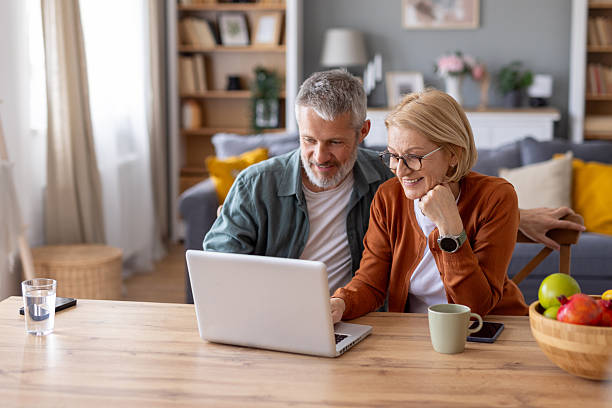 istock Elderly couple sharing a loving moment at their desk 2247203955
