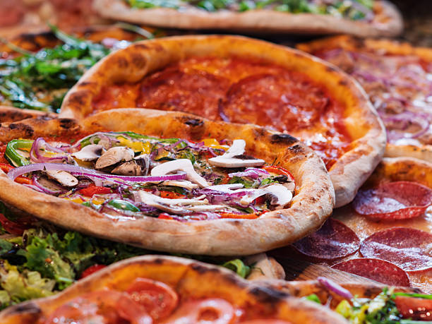 istock Delicious Assortment of Gourmet Pizzas with Toppings 2247207451