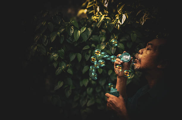 Young man playing with bubbles in the living room.